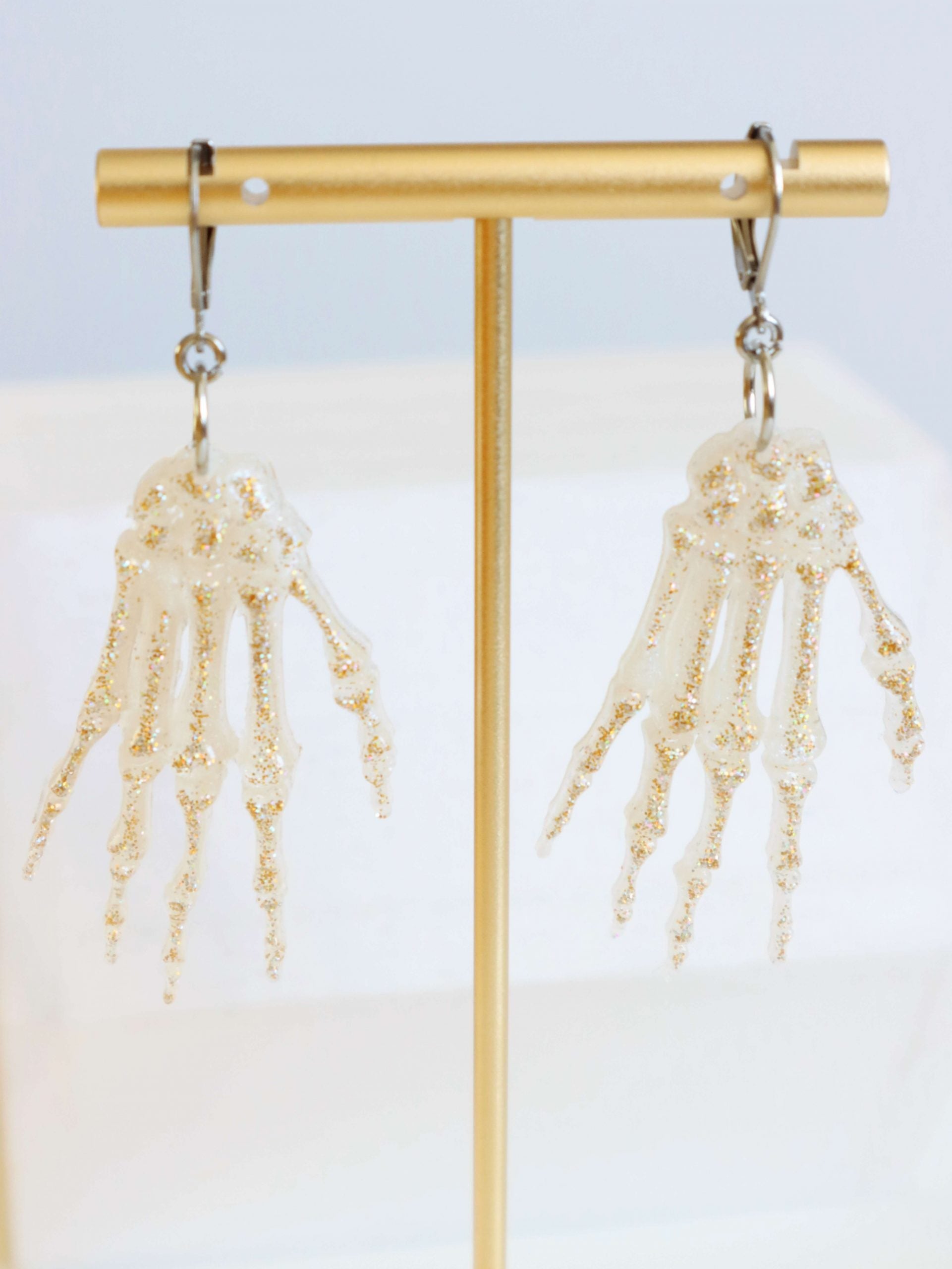 gold-glitter-skeleton-hand-statement-earrings-by-kaleidoscopes-and-polkadots